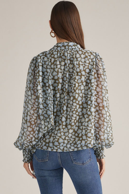 A chic leopard print top featuring dramatic balloon sleeves, a feminine self-tie neckline, and comfortable smocked cuffs for an effortlessly stylish look.