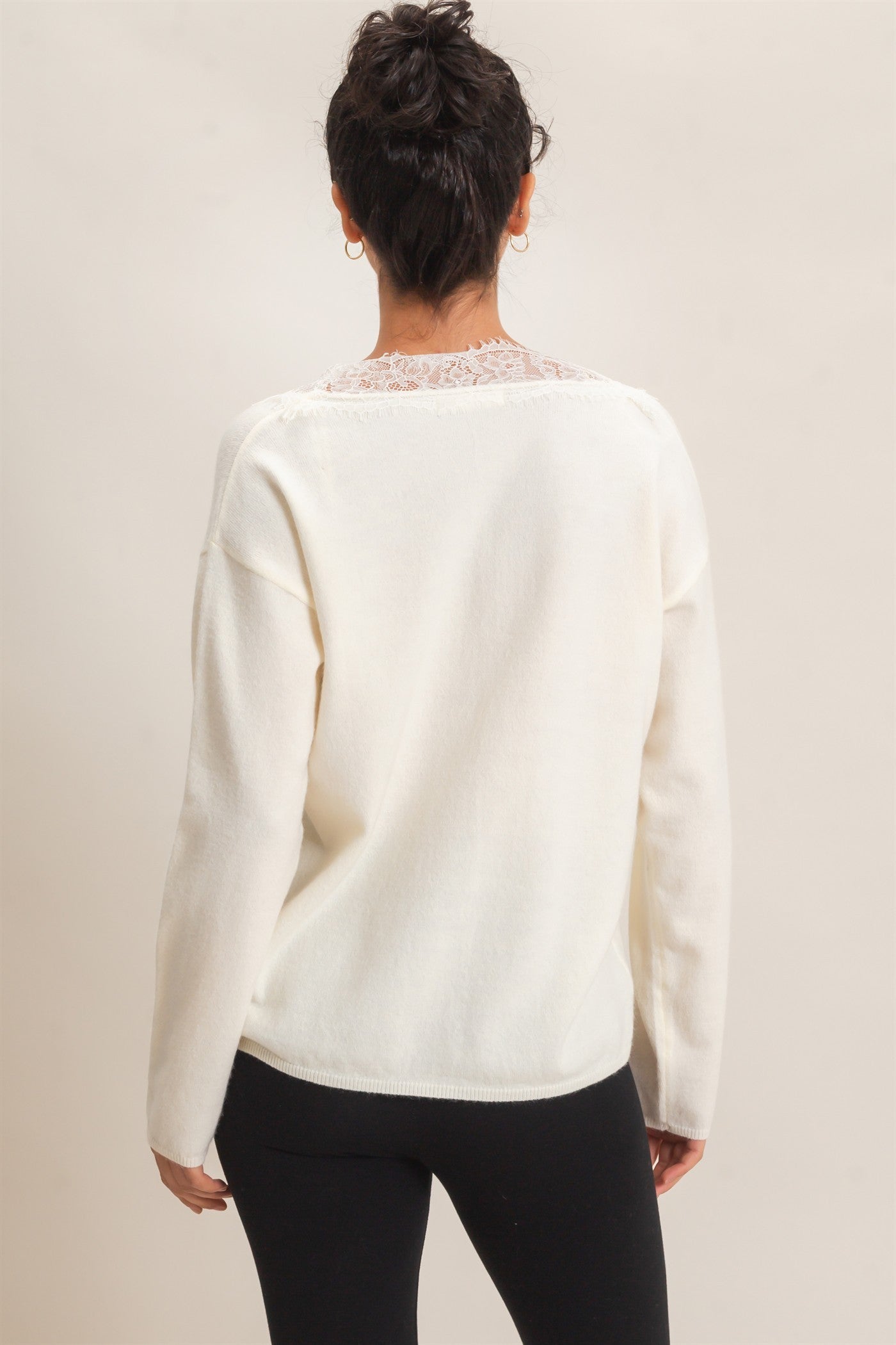 A feminine lace trim V-neck sweater featuring a relaxed silhouette, soft knit fabric, and elegant details for effortless everyday style.
