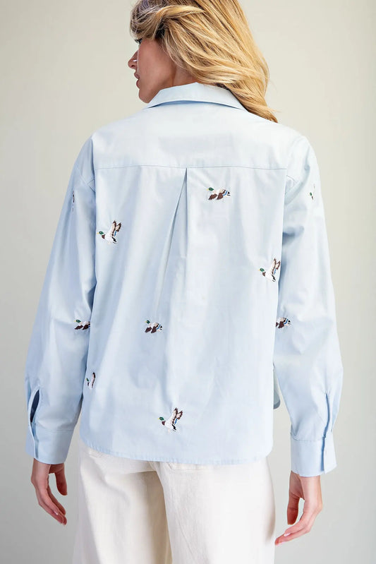 A timeless button-down shirt featuring charming embroidered mallard ducks, crisp tailoring, and an effortlessly polished silhouette.