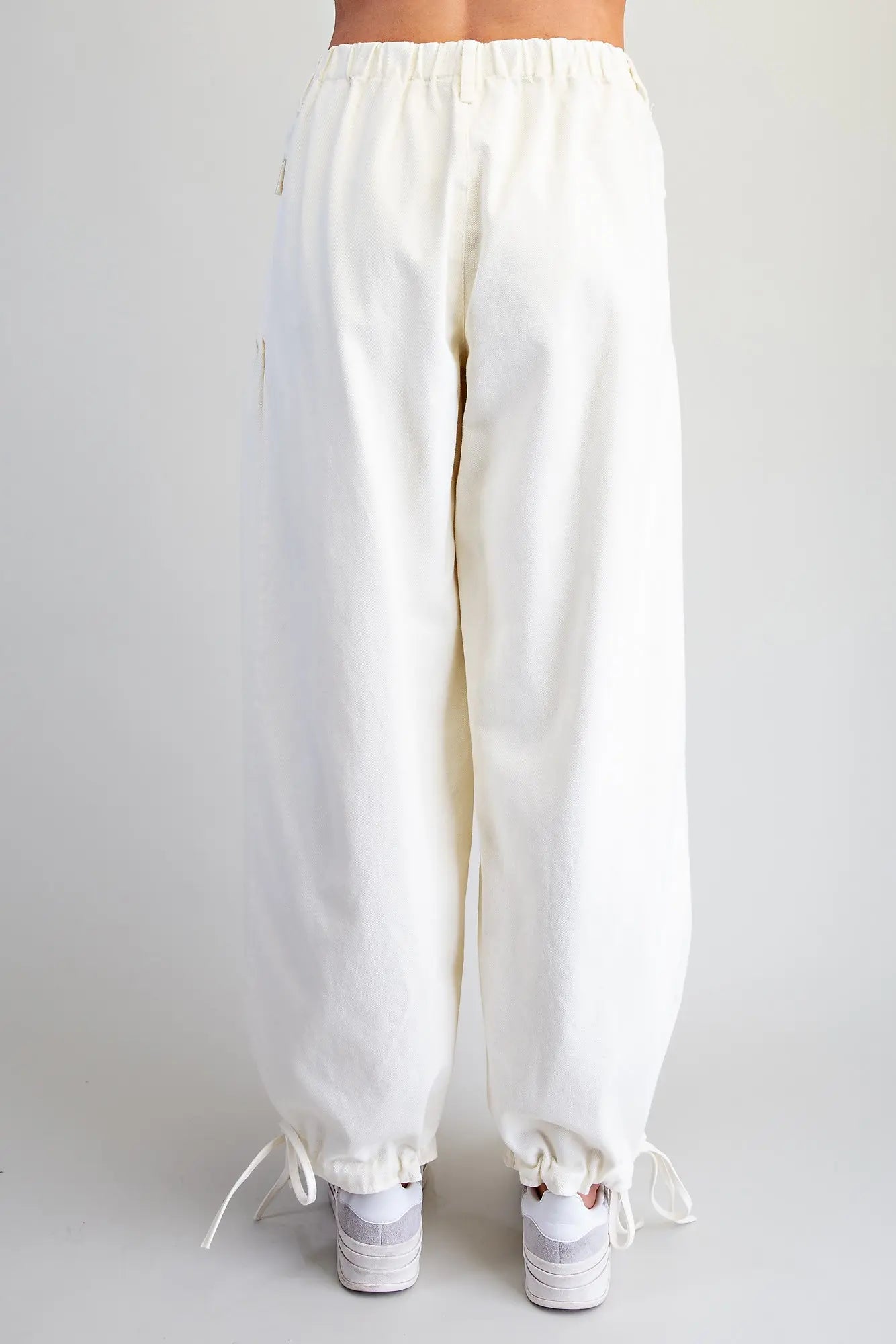 Relaxed mineral washed harem pants featuring adjustable tie cuffs, utility-inspired pockets, and a comfortable elastic back waistband for effortless everyday style.