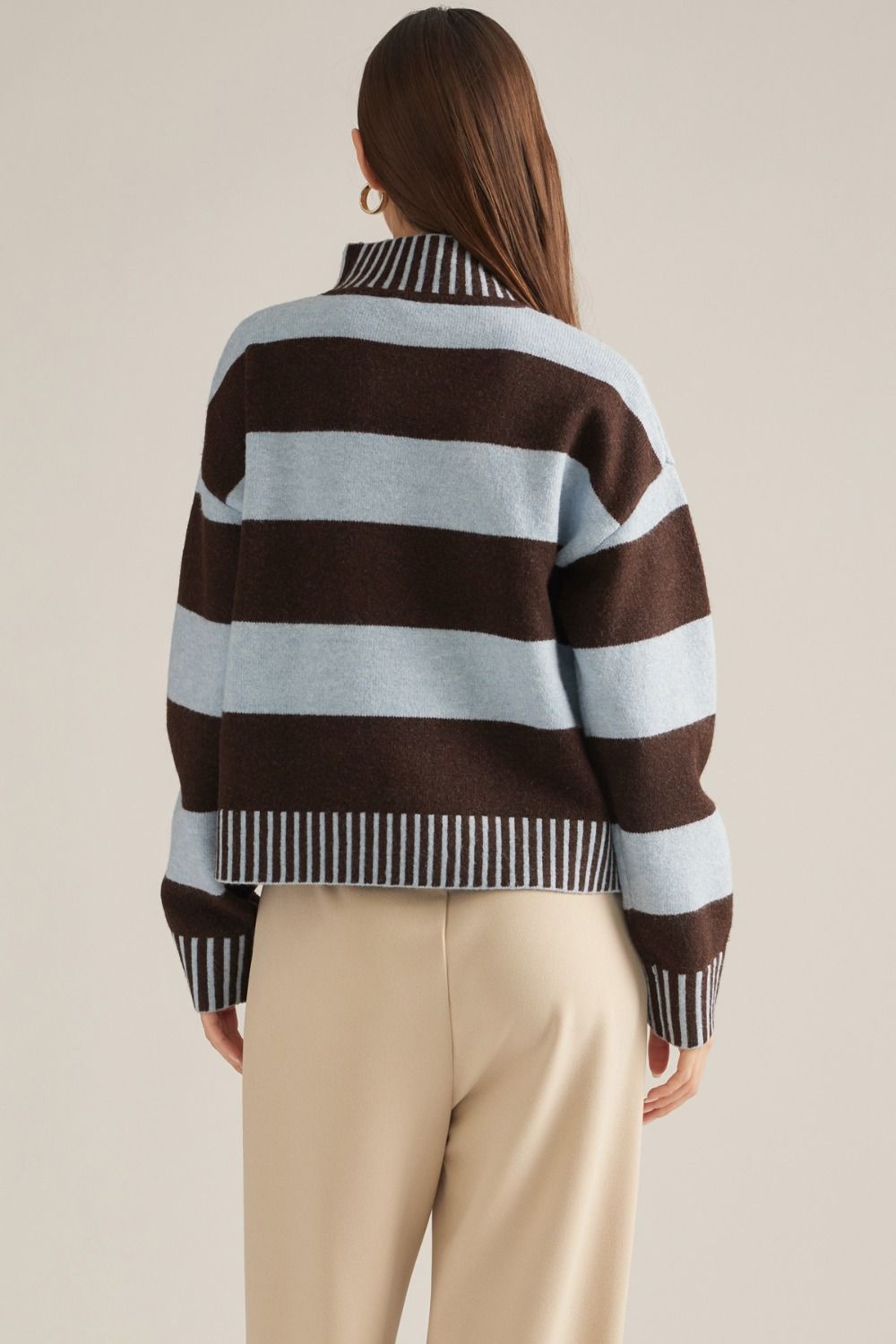 A cozy striped sweater featuring a classic mock neckline, long sleeves, and ribbed trim for an effortlessly polished cold-weather look.