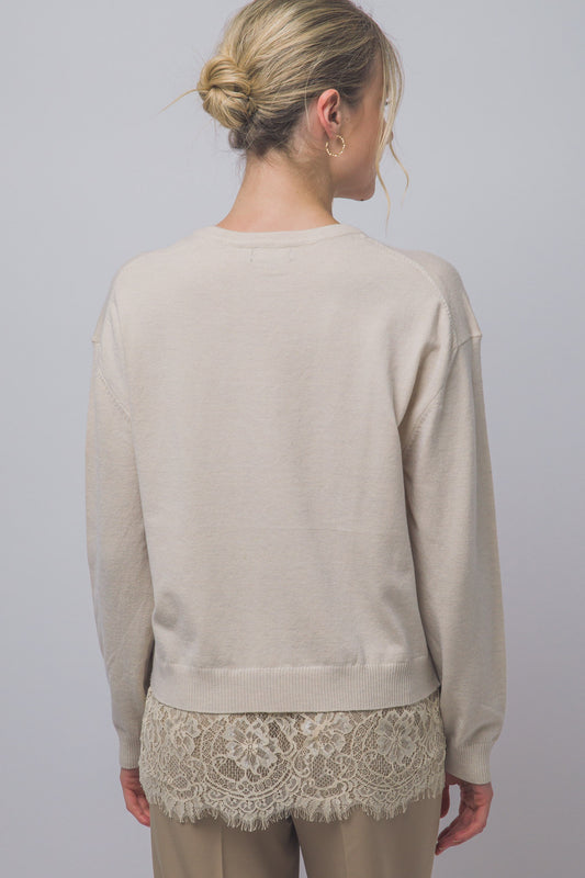 Cozy meets feminine in this oversized V-neck sweater, featuring long sleeves and a delicate lace-trim hem for a romantic, effortlessly chic look.
