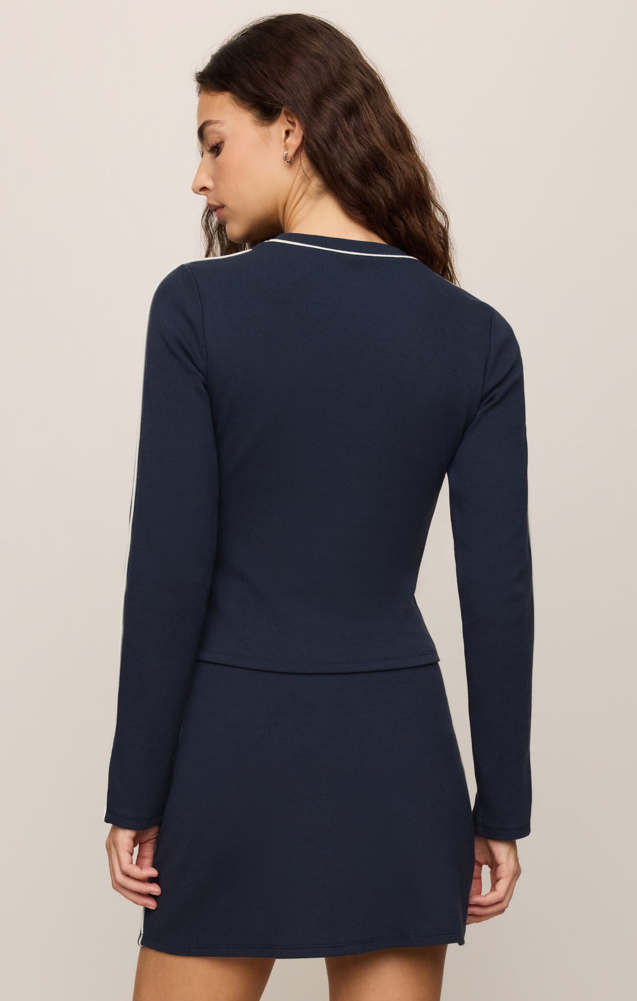 A refined long sleeve knit pullover featuring crisp white contrast trim at the neckline, cuffs, and sleeves for a timeless, elevated look.
