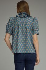 back of printed puff sleeve blouse features a feminine ruffle neckline, self-tie detail, and timeless button-front styling.
