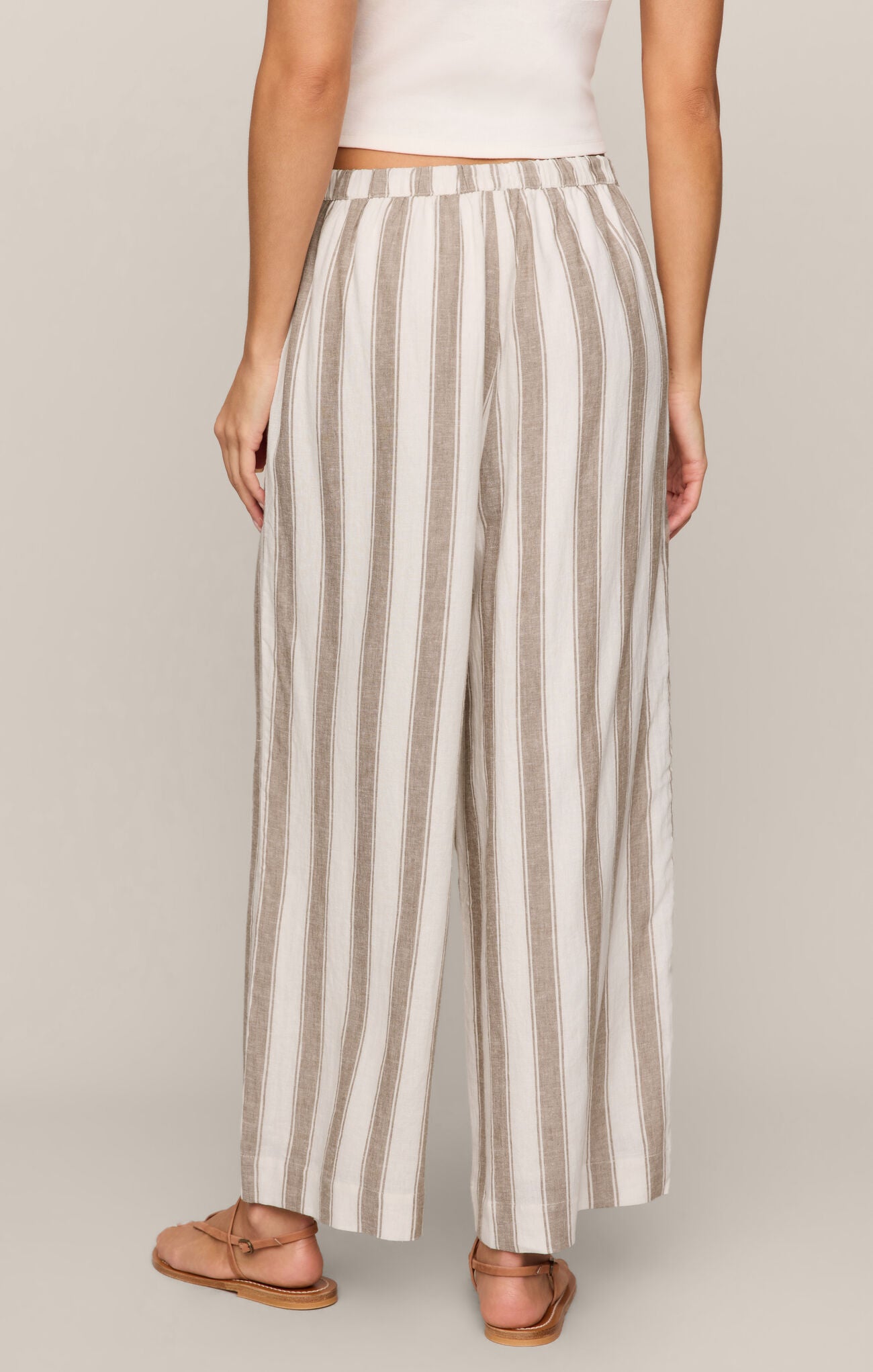Effortlessly chic and breathable, these striped linen-blend pants feature a high-rise fit, adjustable drawcord waist, and relaxed ankle-length silhouette.