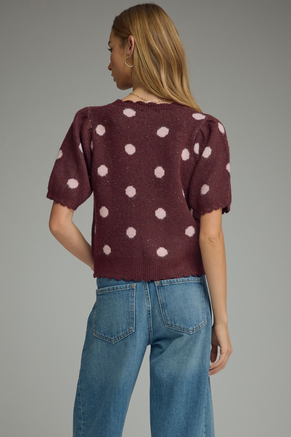back of effortlessly versatile, this lightweight polka dot knit top features feminine puff sleeves and delicate scalloped trim for timeless boutique style.