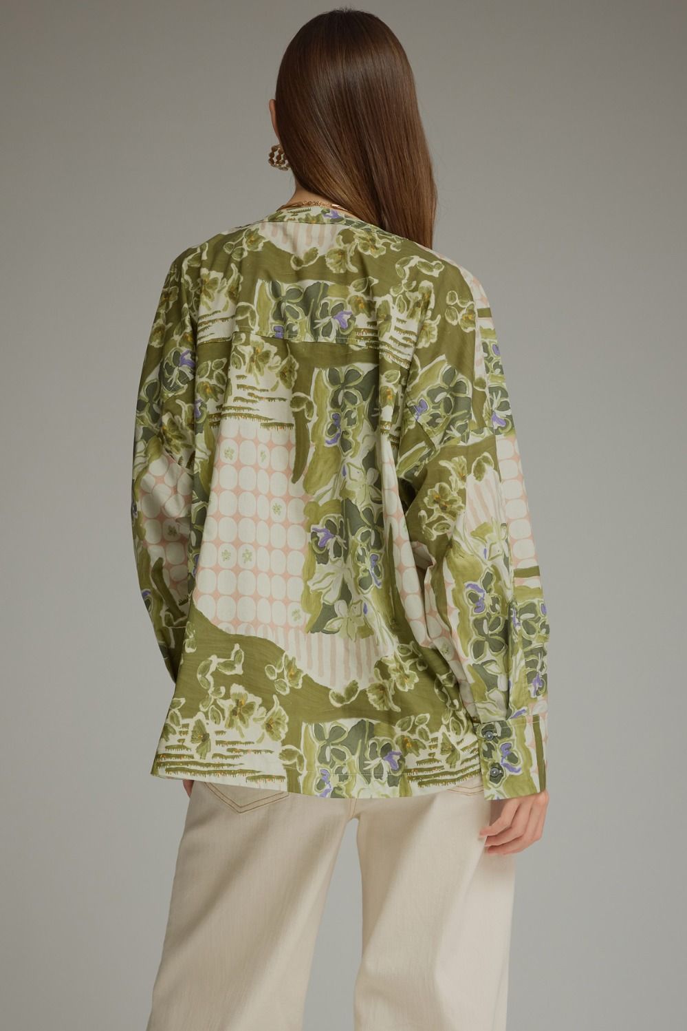 A feminine printed top featuring dramatic balloon sleeves, a flattering V-neck, and a self-tie waist that creates a beautiful peplum silhouette.