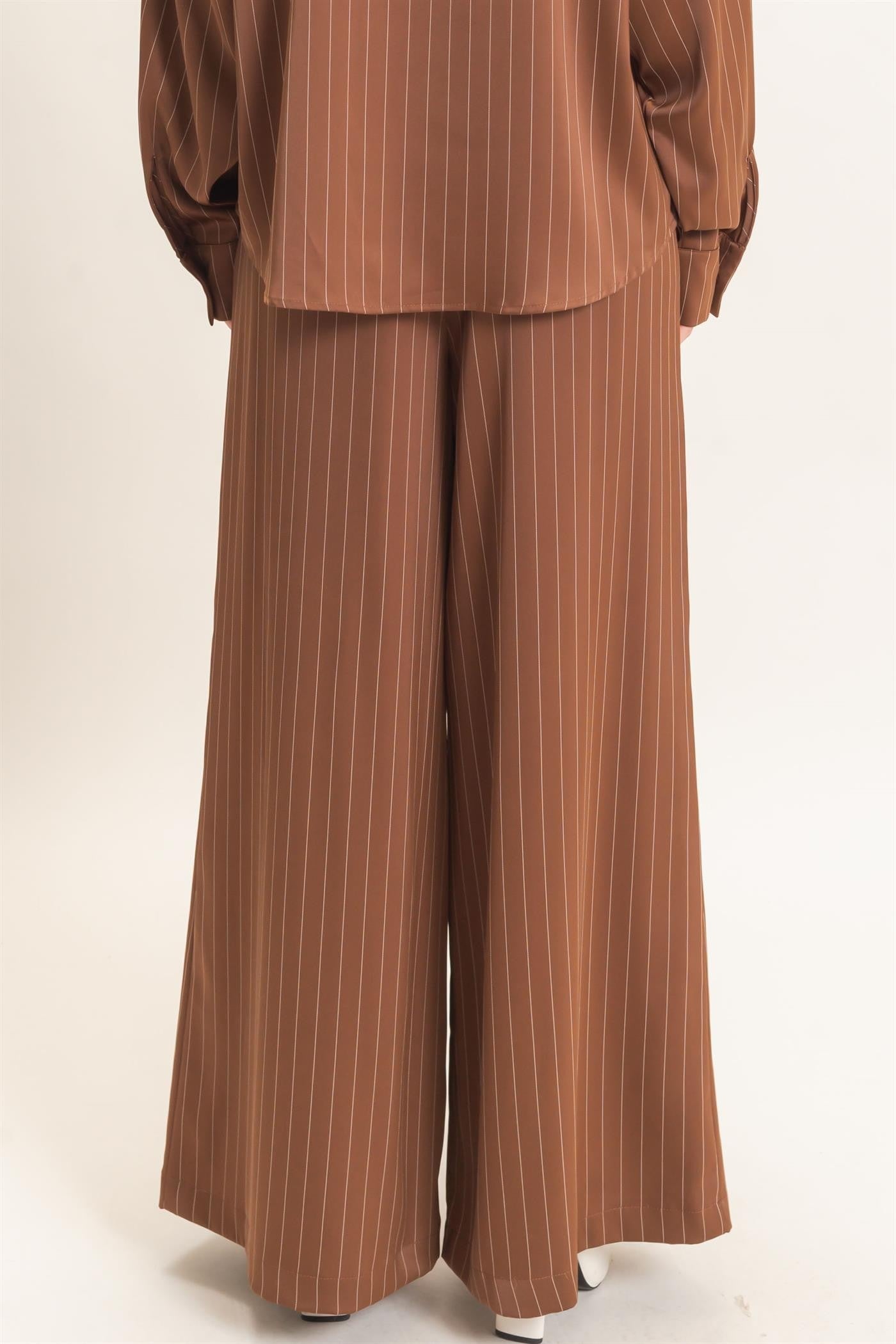 Polished pinstripes meet effortless comfort in these wide-leg pants featuring a flexible elastic waistband and flattering self-tie waist belt.