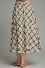 A breezy plaid midi skirt featuring a flattering self-tie waist and feminine ruffle detailing for effortless everyday elegance.

