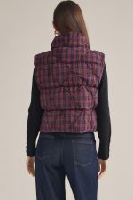 A cozy-chic plaid vest featuring a high neck, padded quilted construction, and a convenient front zipper for effortless layering through the cooler seasons.