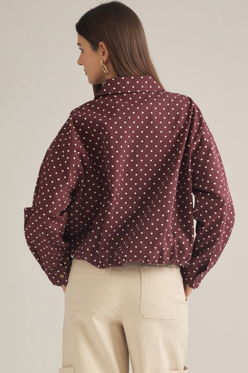 A lightweight polka dot jacket featuring a collared neckline, zip-front closure, and elastic hem for effortless everyday layering.
