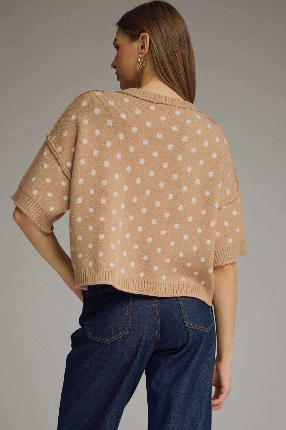 A charming polka dot knit top featuring a classic round neckline, short sleeves, and ribbed trim for a polished everyday look.

