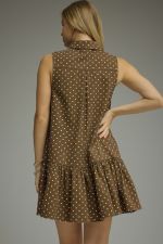 A chic polka dot mini dress featuring an attached neck tie, button-front design, and a timeless sleeveless silhouette.

