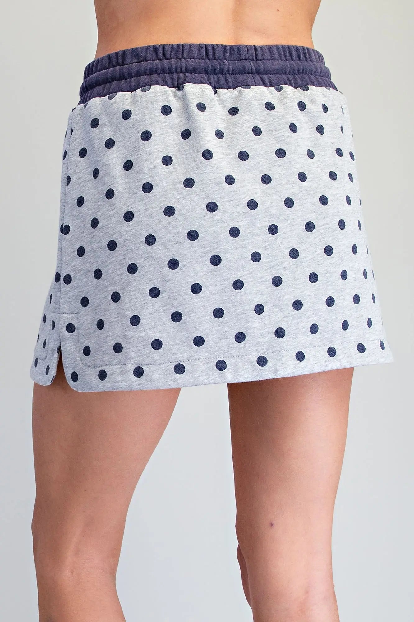 A playful mineral washed skort featuring a classic polka dot print, built-in shorts, and a comfortable drawstring waistband for effortless everyday style.