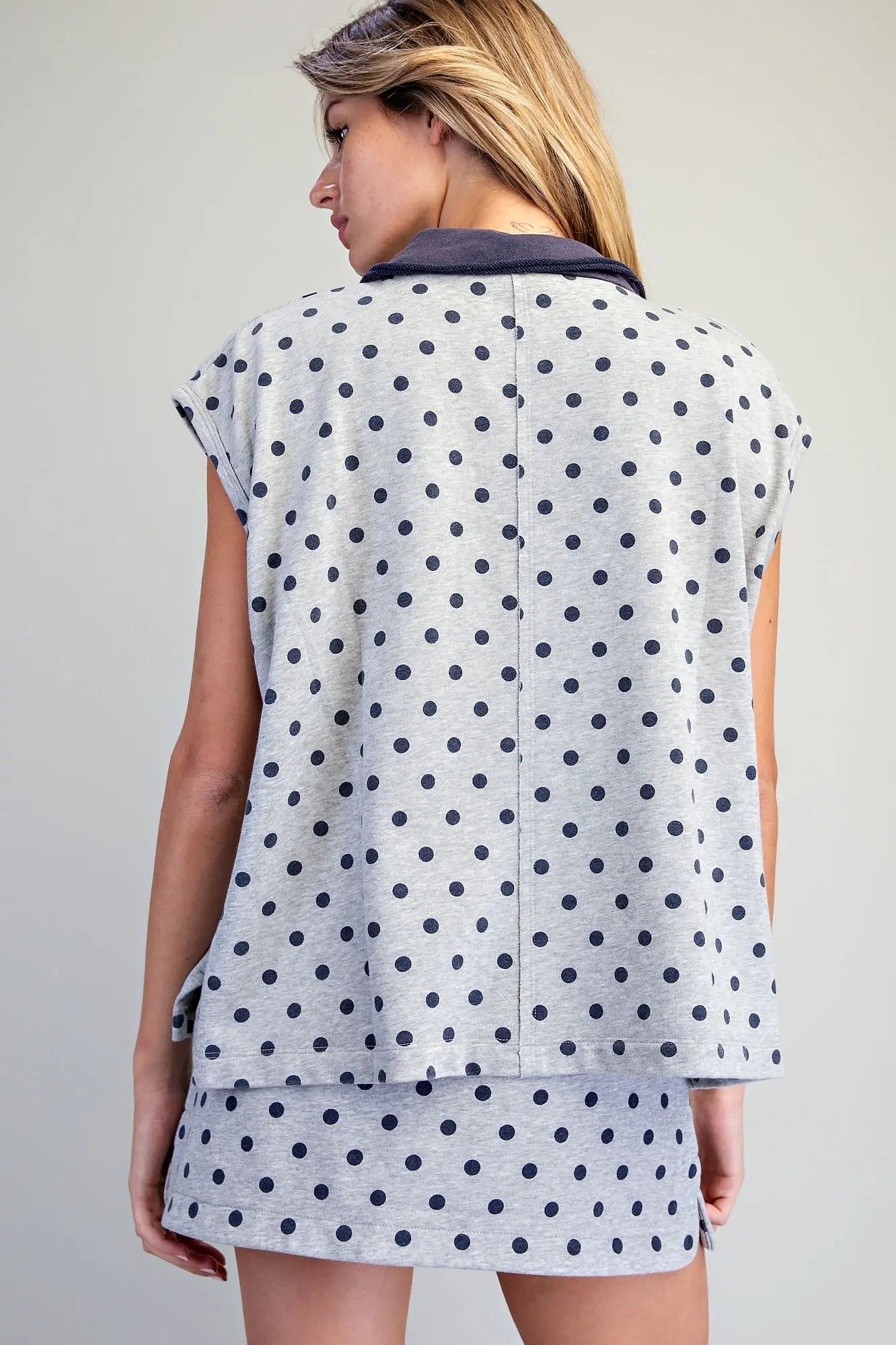 A relaxed mineral washed polo top featuring playful polka dots, cap sleeves, and a raw edge collar for effortless casual style.
