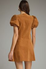 A feminine and effortlessly flattering mini dress featuring a V-neckline, romantic puff sleeves, convenient side pockets, and an easy front zipper closure.