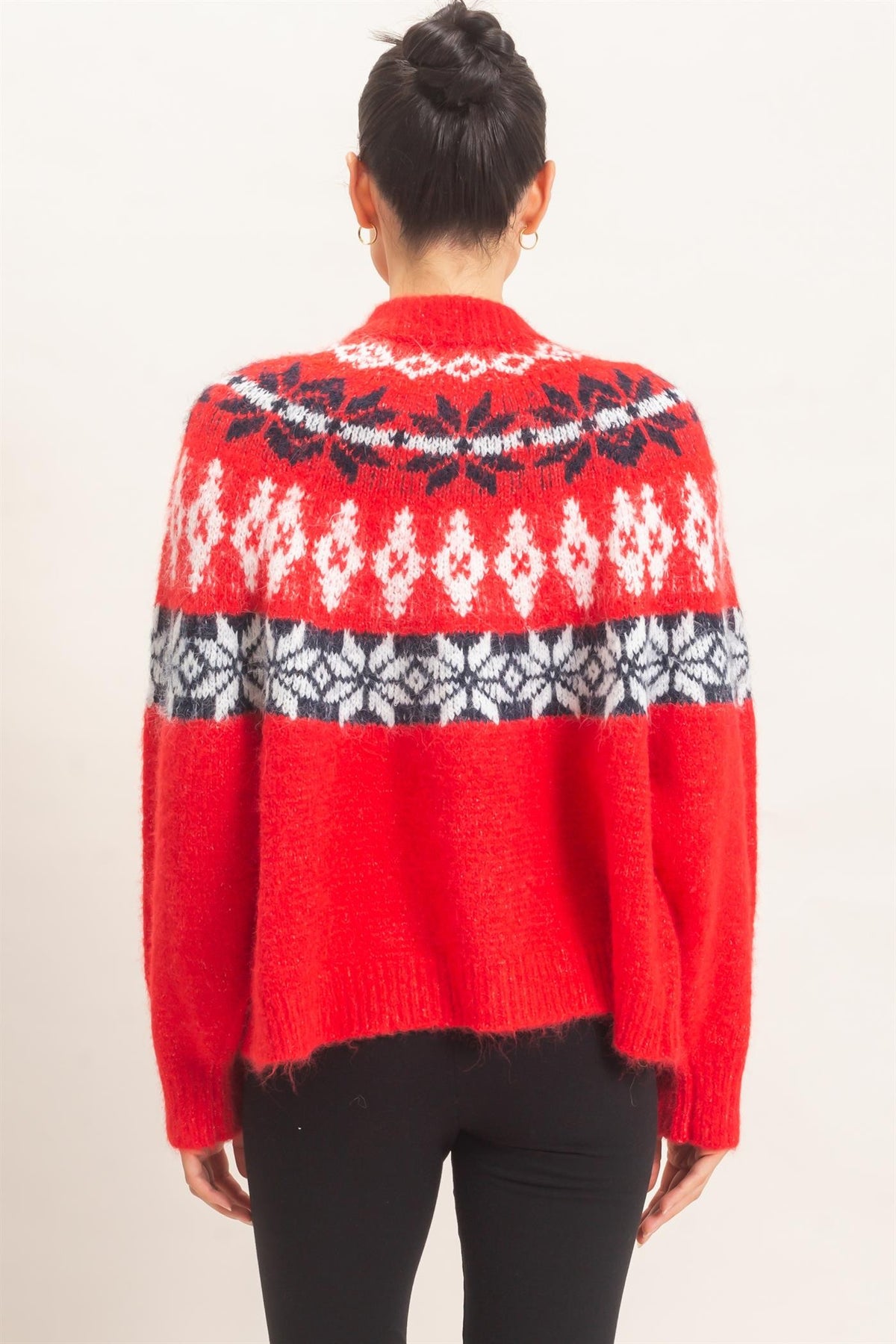 A cozy Fair Isle cardigan featuring classic snowflake motifs, a soft fuzzy texture, and a relaxed button-front silhouette perfect for chilly days.