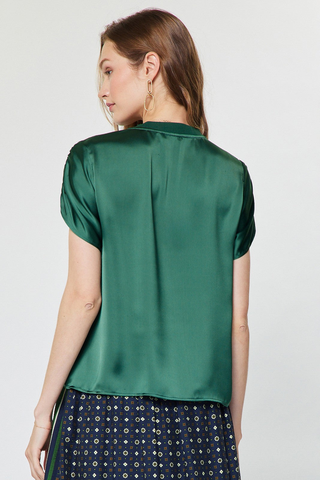 A chic satin-finish blouse featuring contrast neckline and shoulder details, gathered shoulders, and a relaxed boxy fit for effortlessly elevated everyday style.