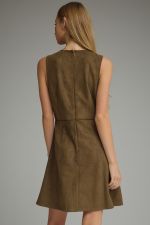 A sleek sleeveless mini dress featuring statement front pockets with metallic chain trim and a clean back-zip closure.