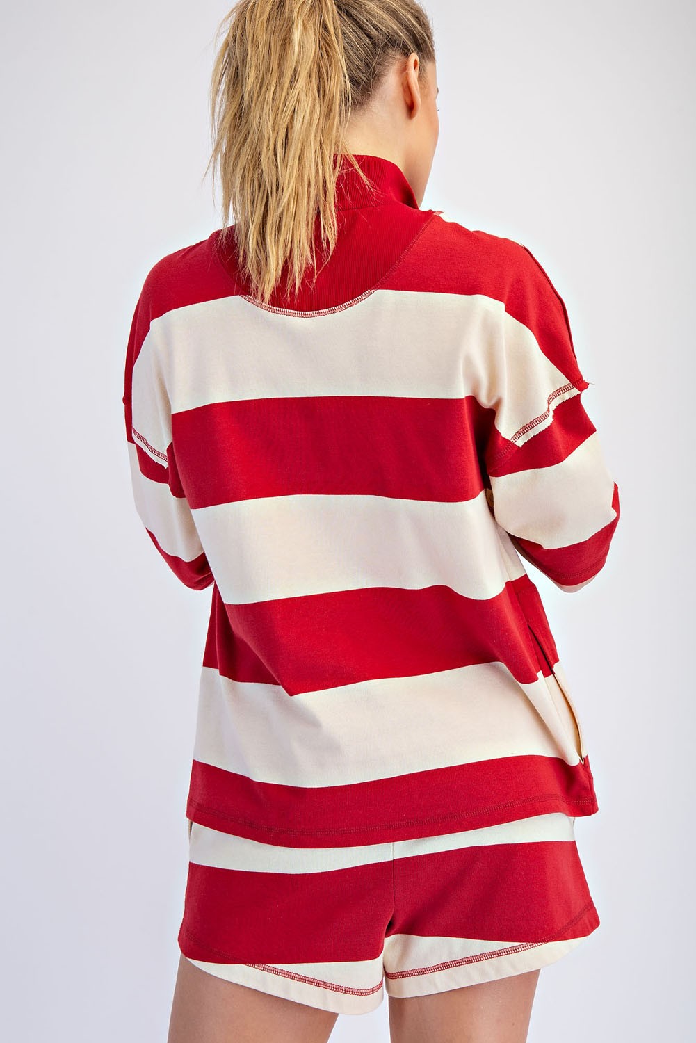 A lightweight striped cotton top with a sporty quarter-zip neckline, relaxed oversized fit, and effortlessly cool raw-edge details.
