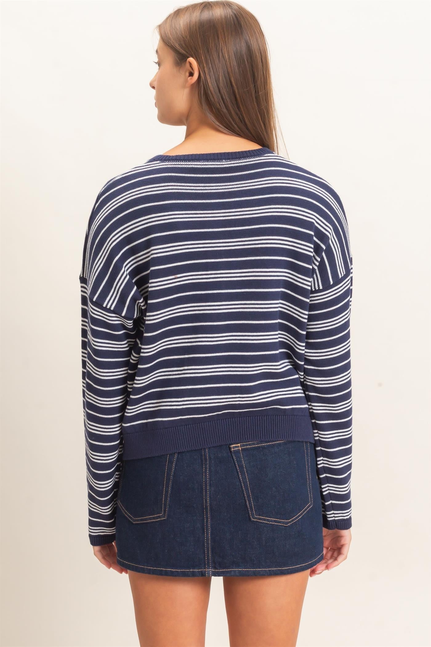 A classic striped ribbed sweater with a modern henley neckline and cozy long sleeves, perfect for effortless everyday style.
