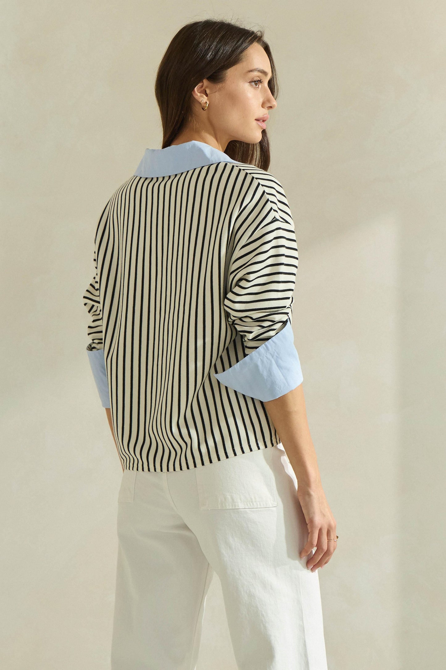 A timeless striped knit top featuring a flattering V-neckline, contrast neckline and cuffs, and an effortlessly polished silhouette.