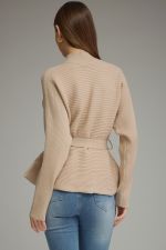A polished ribbed peplum sweater with a flattering self-tie waist and mock neckline for an effortlessly feminine, put-together look.