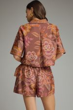 A feminine botanical print two-piece set featuring a breezy split-V top and wrap-front skort for effortless warm-weather style.