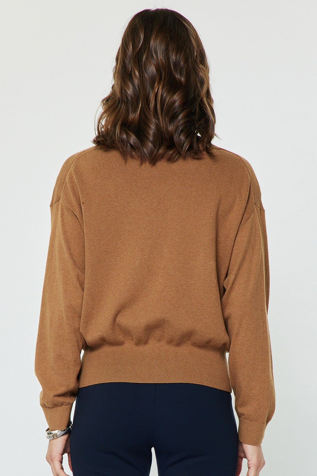 A beautifully soft knit sweater with a relaxed fit, elegant twist-front detail, and flowing dolman sleeves for effortless everyday style.