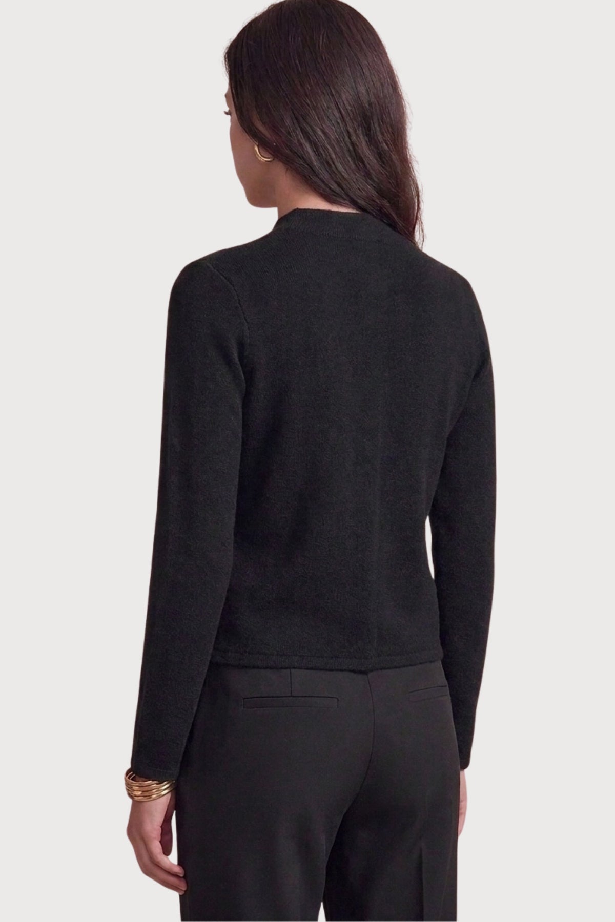 A polished military-inspired knit jacket featuring a structured silhouette, collarless crew neckline, and statement dome buttons for a timeless, tailored look.