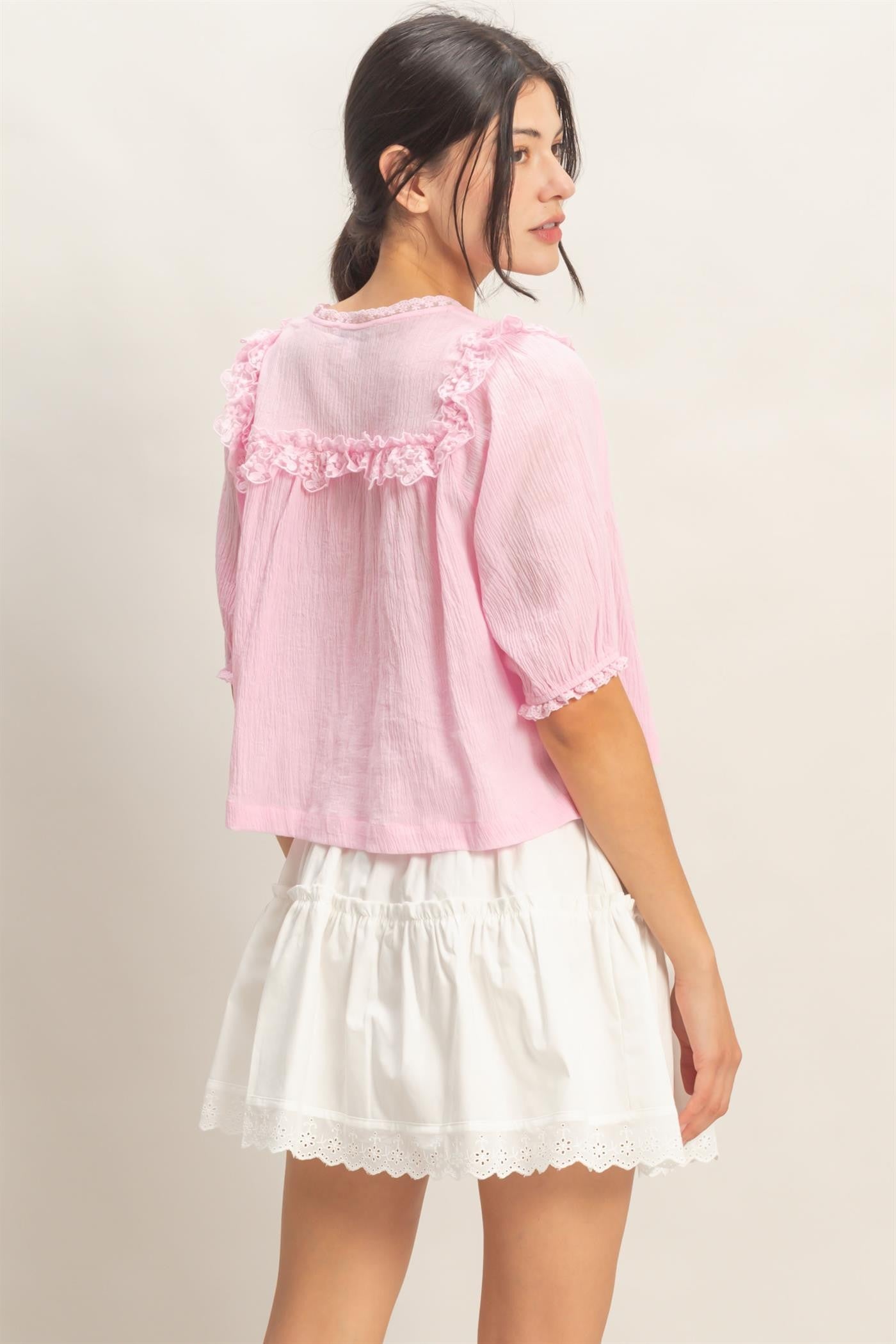  Lace Trim V-Neck Top features delicate ruffled lace accents and a relaxed silhouette 