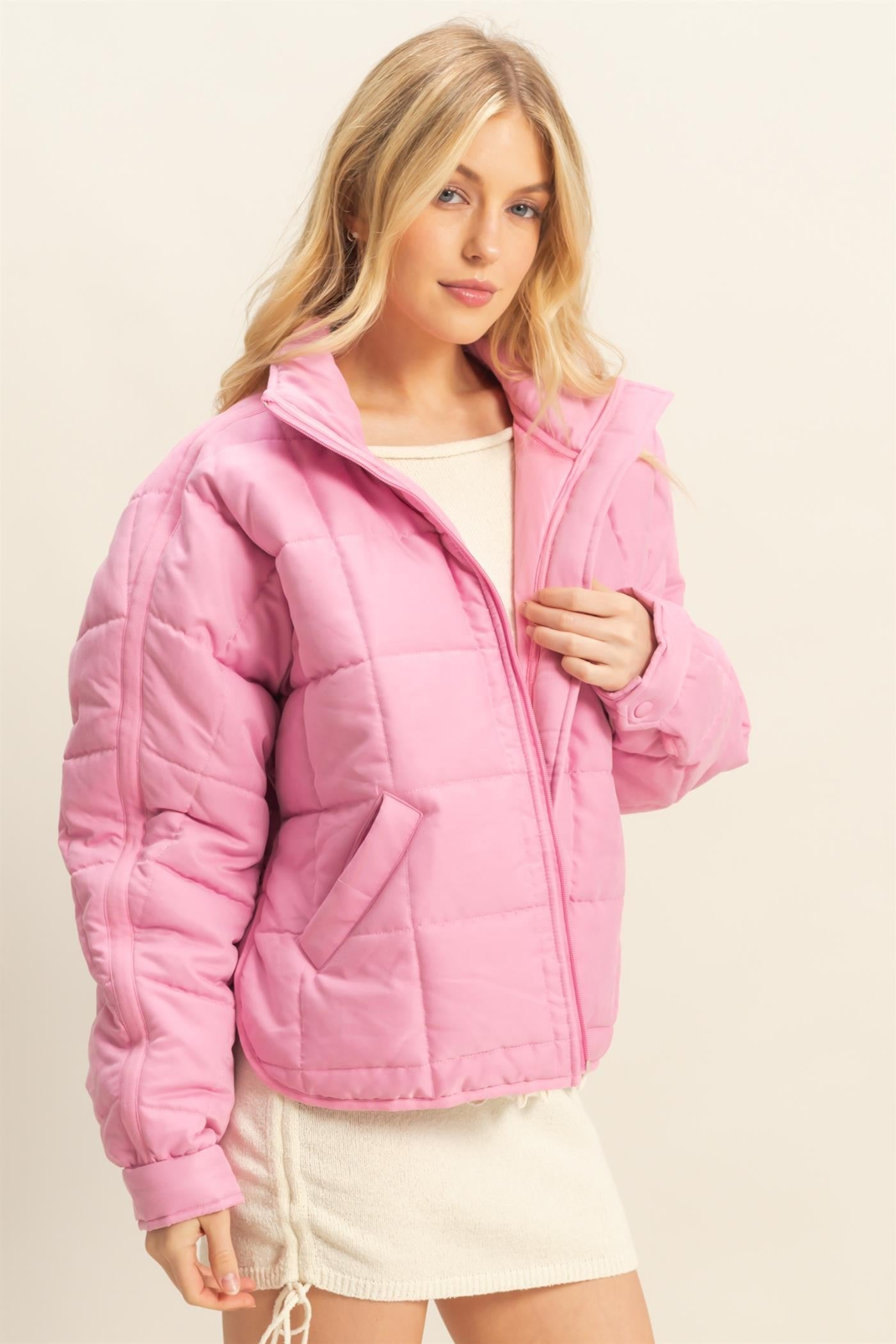 A sophisticated quilted puffer jacket with a stand collar, cozy fit, and timeless style for chilly days.
