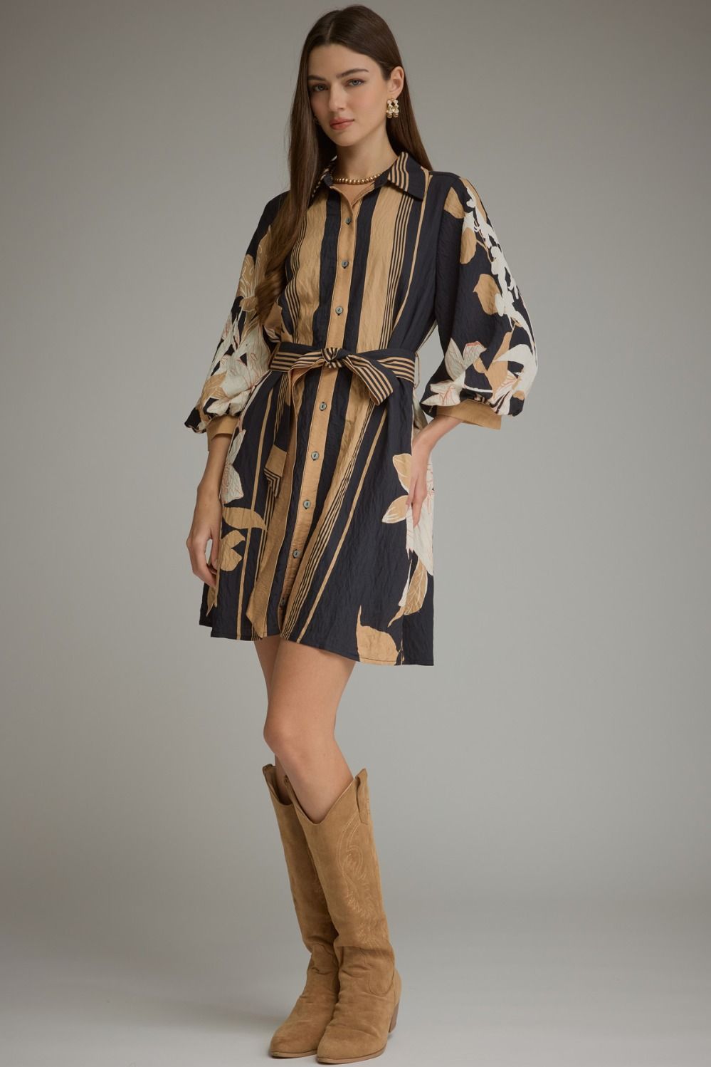 A feminine printed mini dress featuring dramatic balloon sleeves, a classic shirt collar, button-front closure, and a flattering self-tie waist.