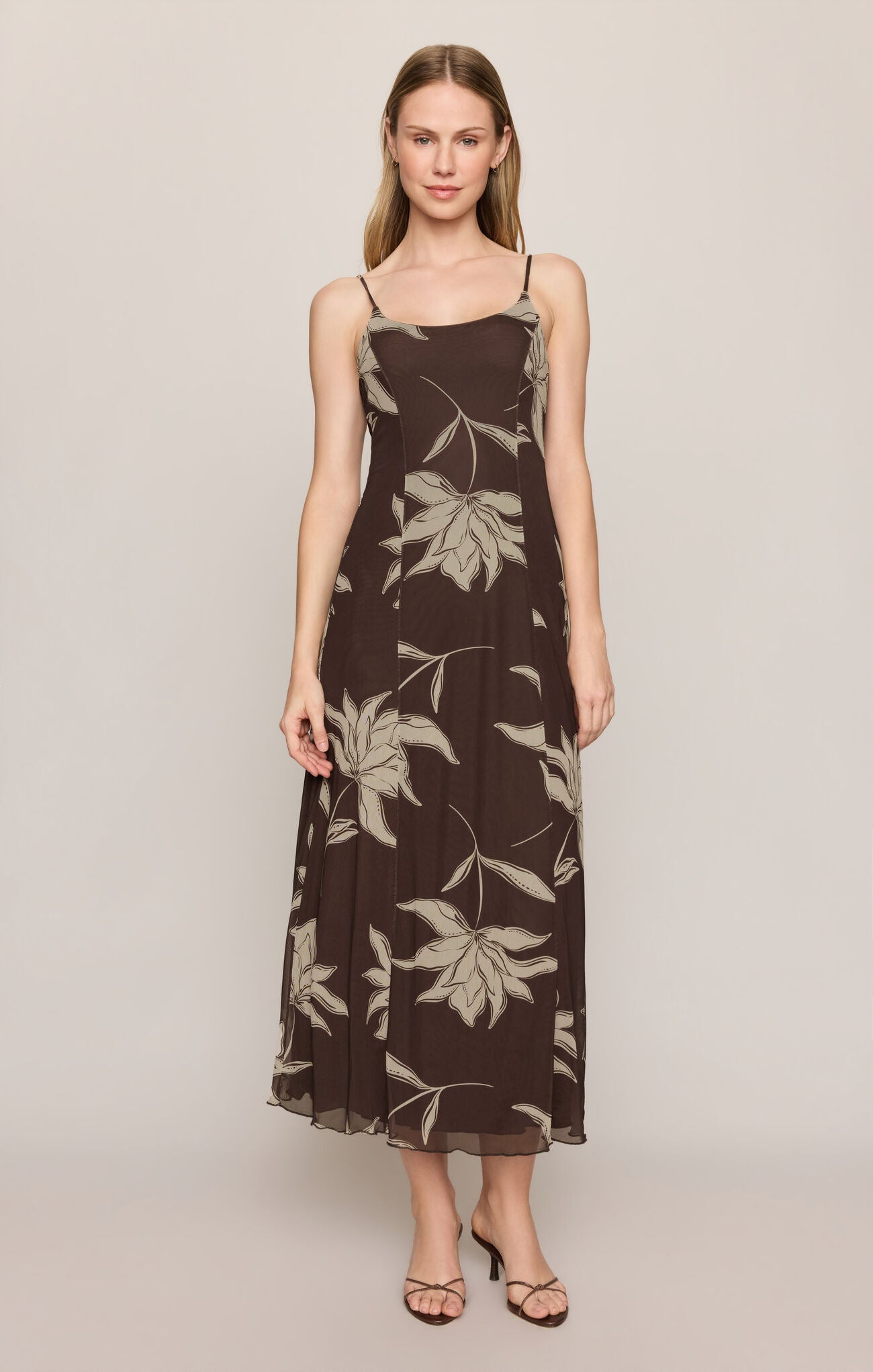 A feminine floral midi dress featuring a scoop neckline, adjustable spaghetti straps, and a soft stretch silhouette for effortless comfort and style.