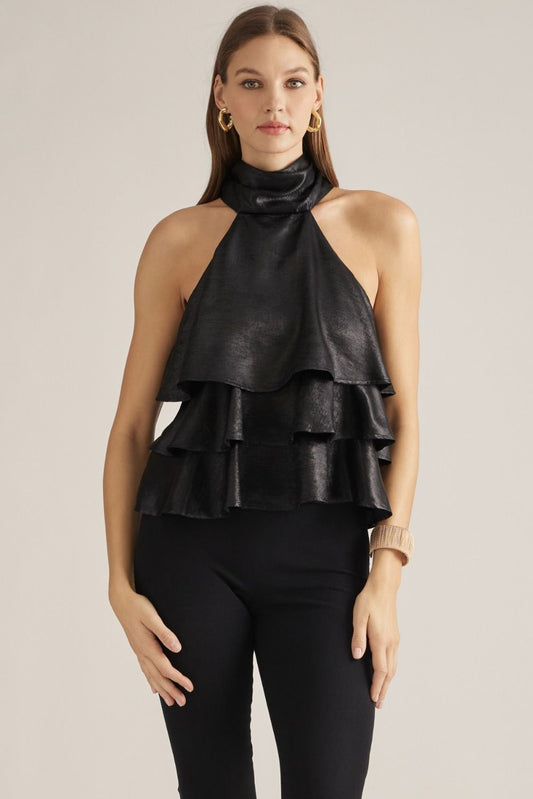 A feminine sleeveless top with layered ruffles, a high neckline, and a long self-tie scarf detail for an effortlessly polished look.