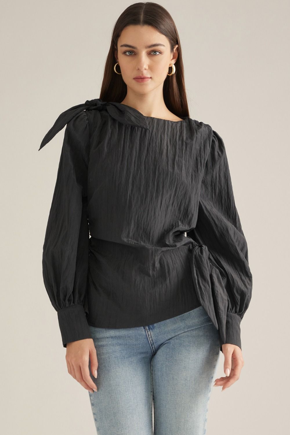 Elevate your wardrobe with this chic long-sleeve blouse featuring a straight neckline, feminine shoulder tie, and flattering side-wrap detail.


