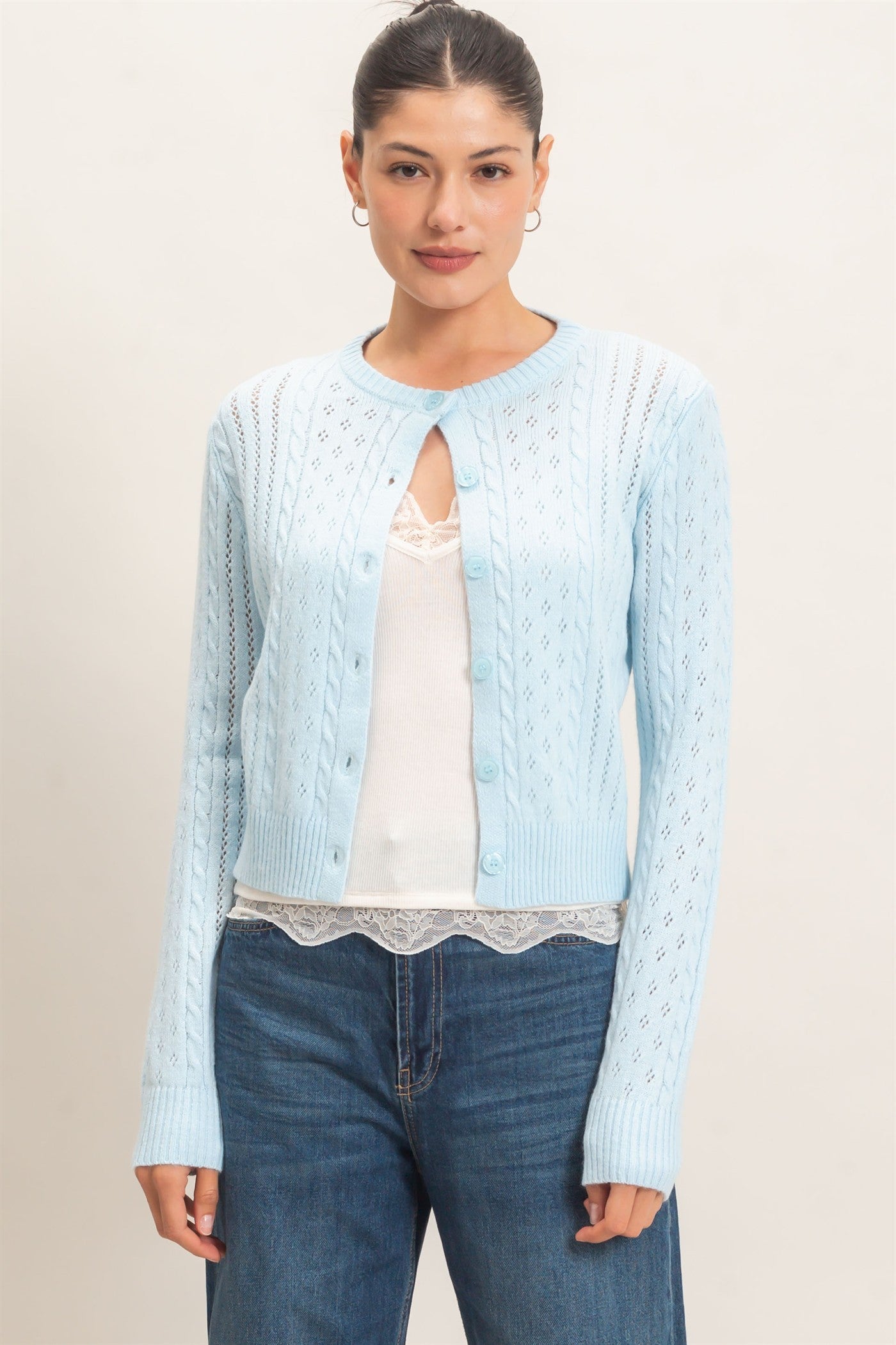 A timeless cable knit cardigan with a classic crew neckline, button-front closure, and textured detailing for cozy, polished style.