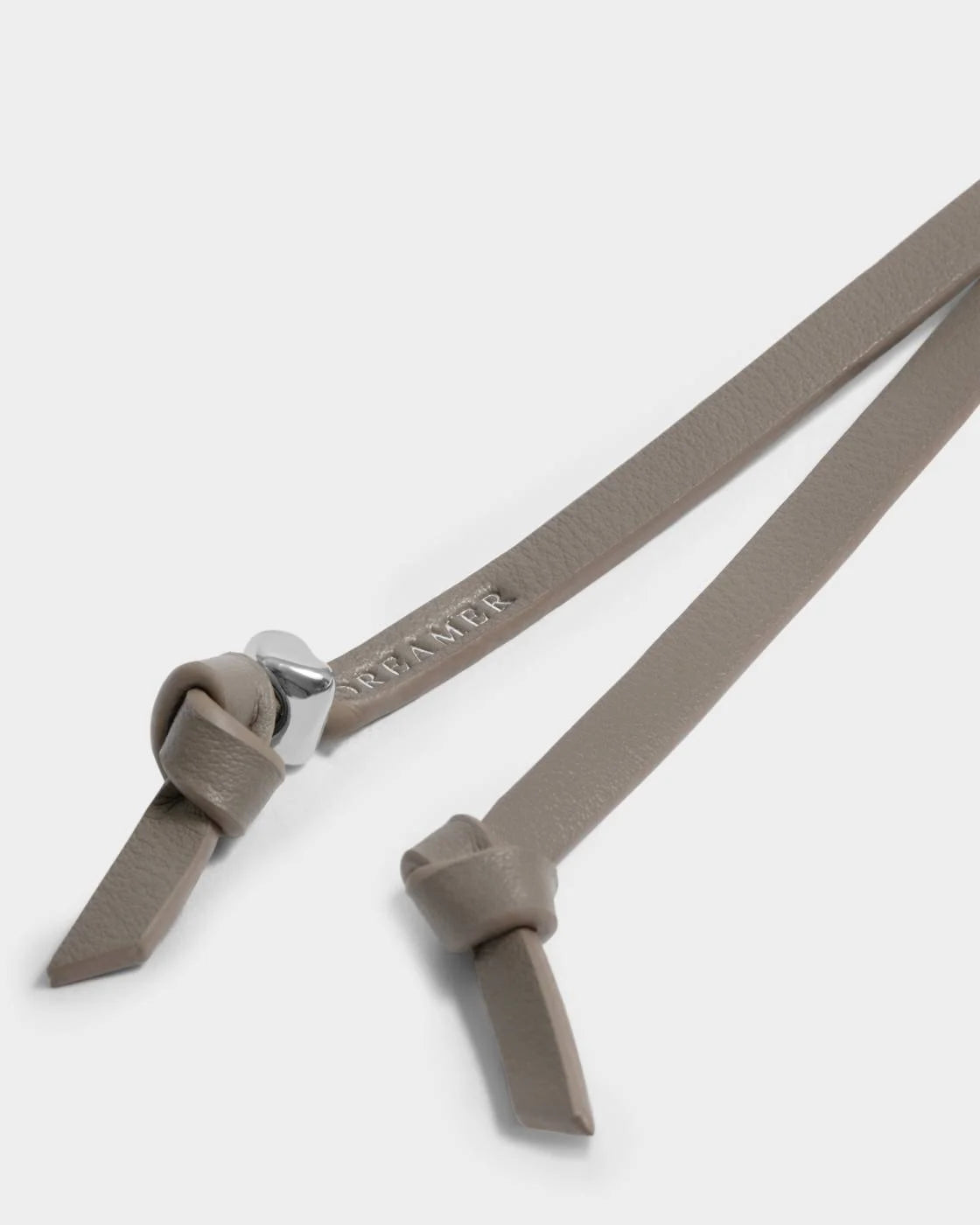 Our Bow Charm Keyring features a sweet bow-shaped design, stamped with the sweet sentiment ‘Dreamer’. Finished with silver-tone signature charm detailing.

