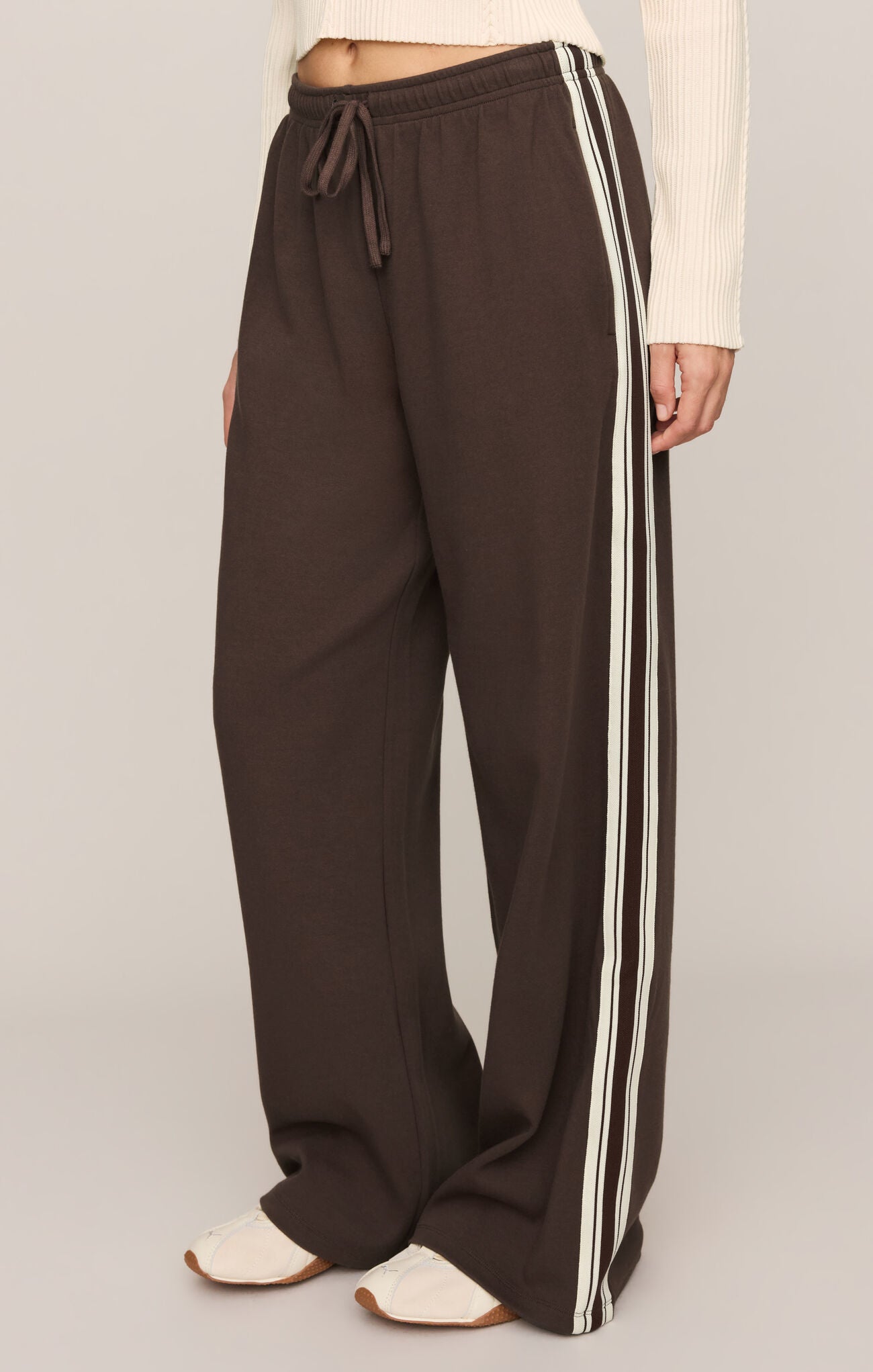 Effortlessly polished and incredibly comfortable, these high-rise knit lounge pants feature a relaxed silhouette, adjustable drawcord waist, and functional pockets for everyday versatility.