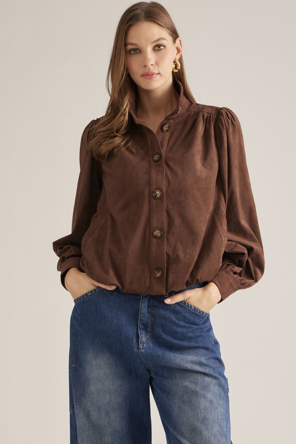 A polished long-sleeve jacket featuring a structured stand collar, gathered shoulder details, and a classic button front for effortless sophistication.


