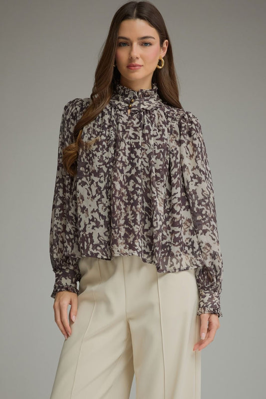 A romantic printed blouse featuring voluminous puff sleeves, a feminine ruffle neckline, and delicate gathered details for an effortlessly polished look.