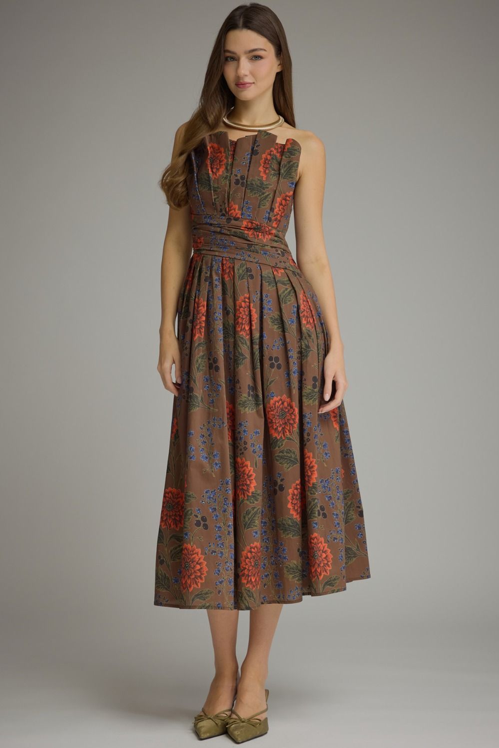 A feminine floral midi dress featuring a unique neckline created by the beautifully pleated bodice, comfortable smocked back, and convenient side pockets.