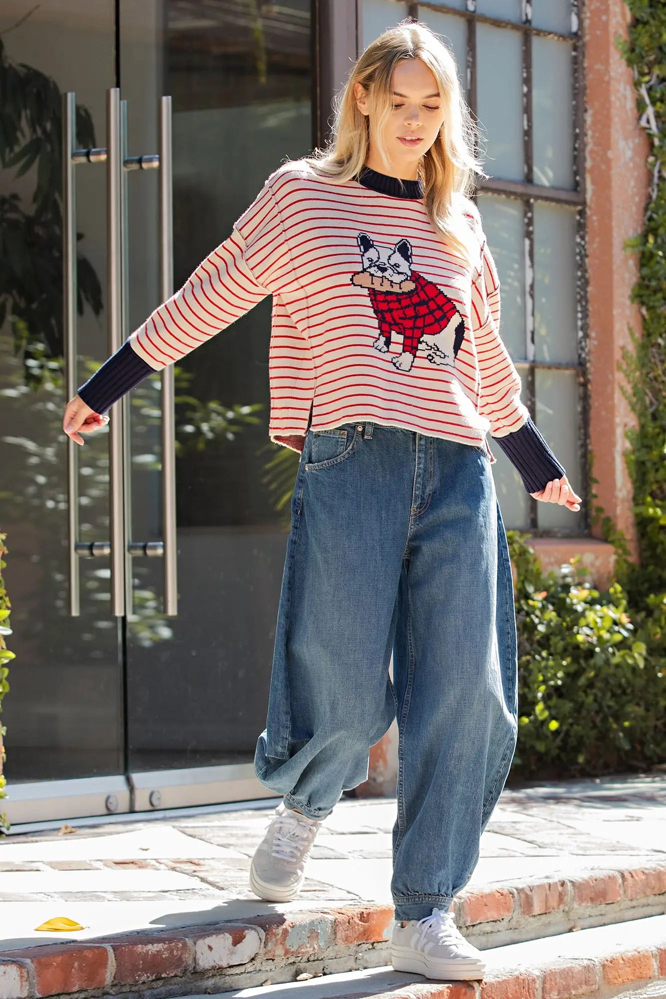 A cozy striped knit sweater featuring an adorable bulldog graphic, relaxed drop shoulders, and side slits for playful boutique style