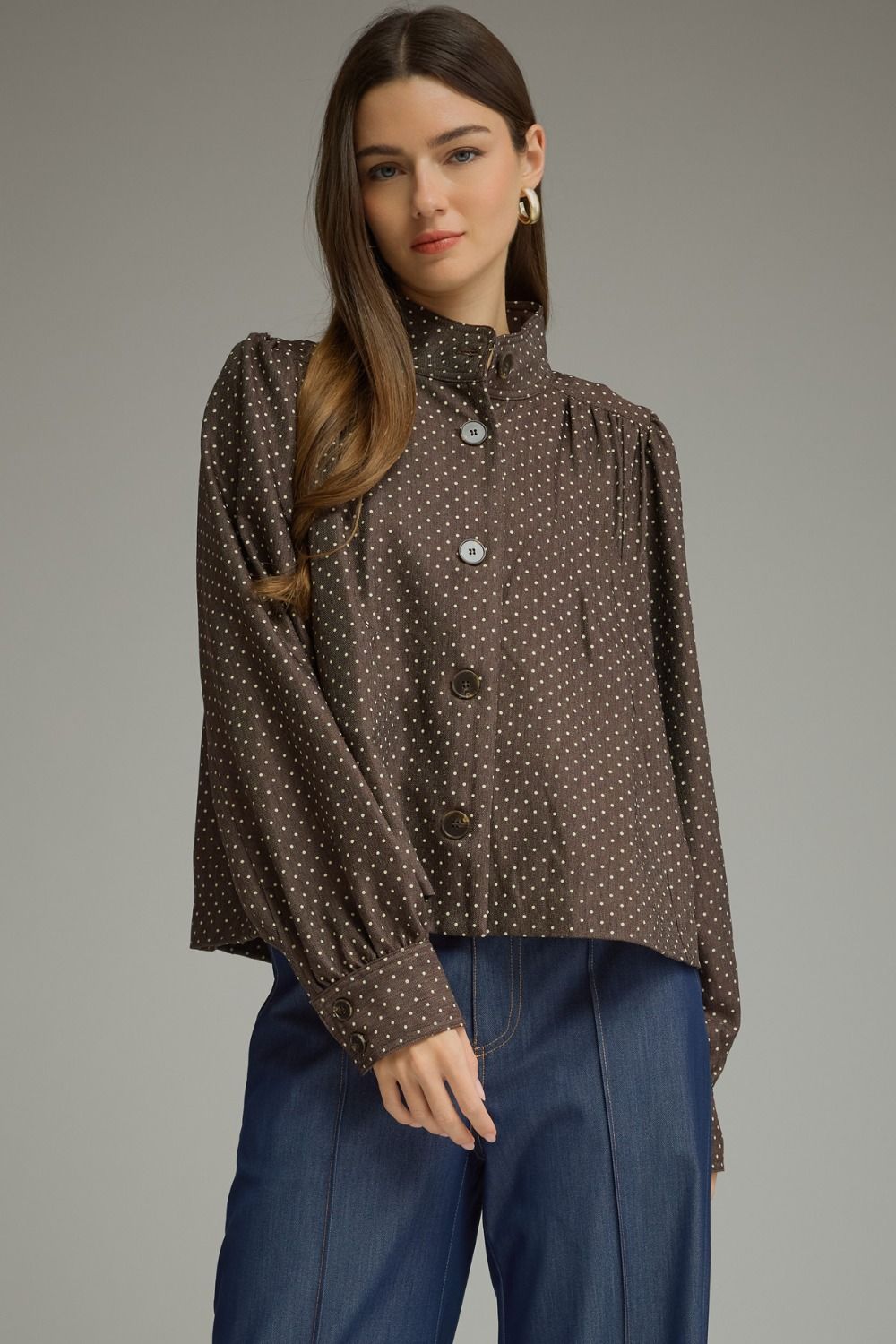 A chic polka dot jacket featuring a polished stand collar, gathered shoulder details, and classic button-front styling in lightweight woven fabric.

