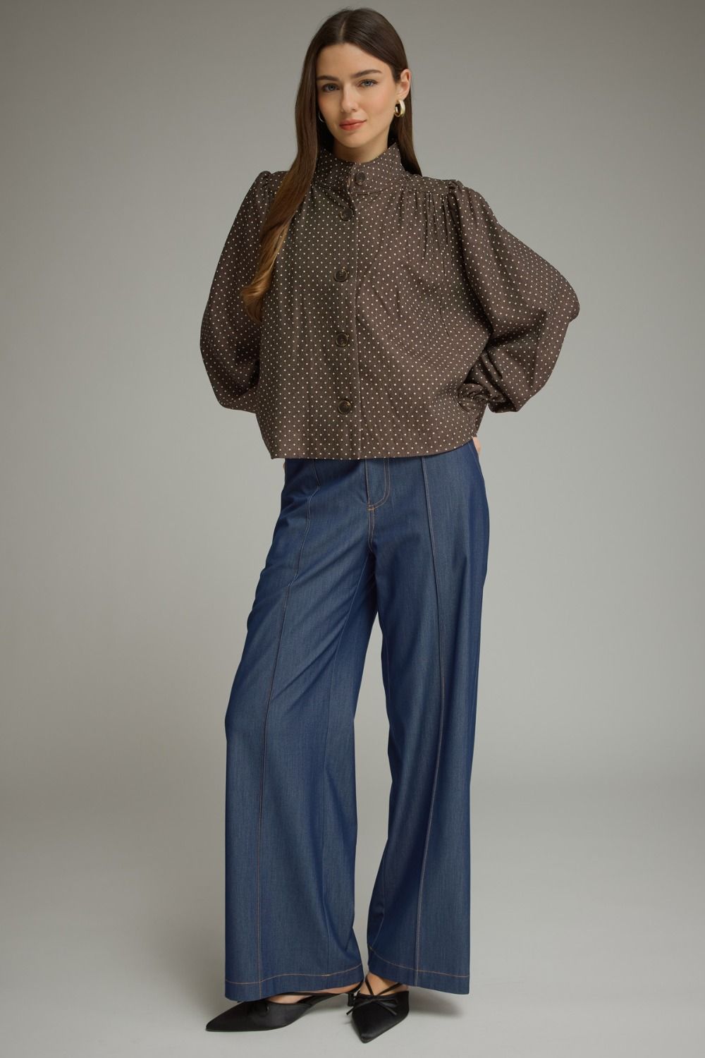 A chic polka dot jacket featuring a polished stand collar, gathered shoulder details, and classic button-front styling in lightweight woven fabric.

