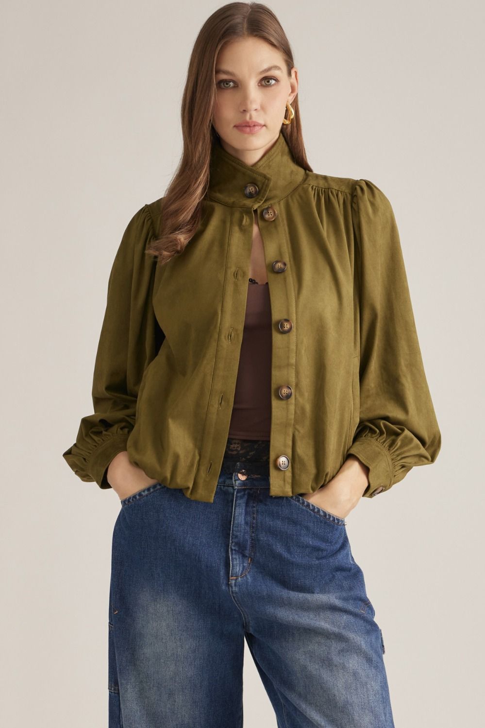 A polished long-sleeve jacket featuring a structured stand collar, gathered shoulder details, and a classic button front for effortless sophistication.

