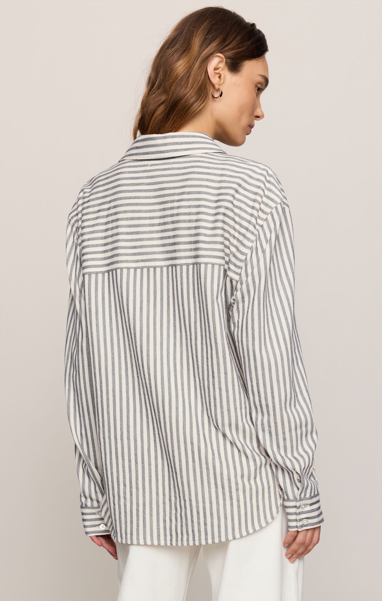 back of collared button-front shirt crafted from silky stretch knit for effortless comfort and elevated everyday style.
