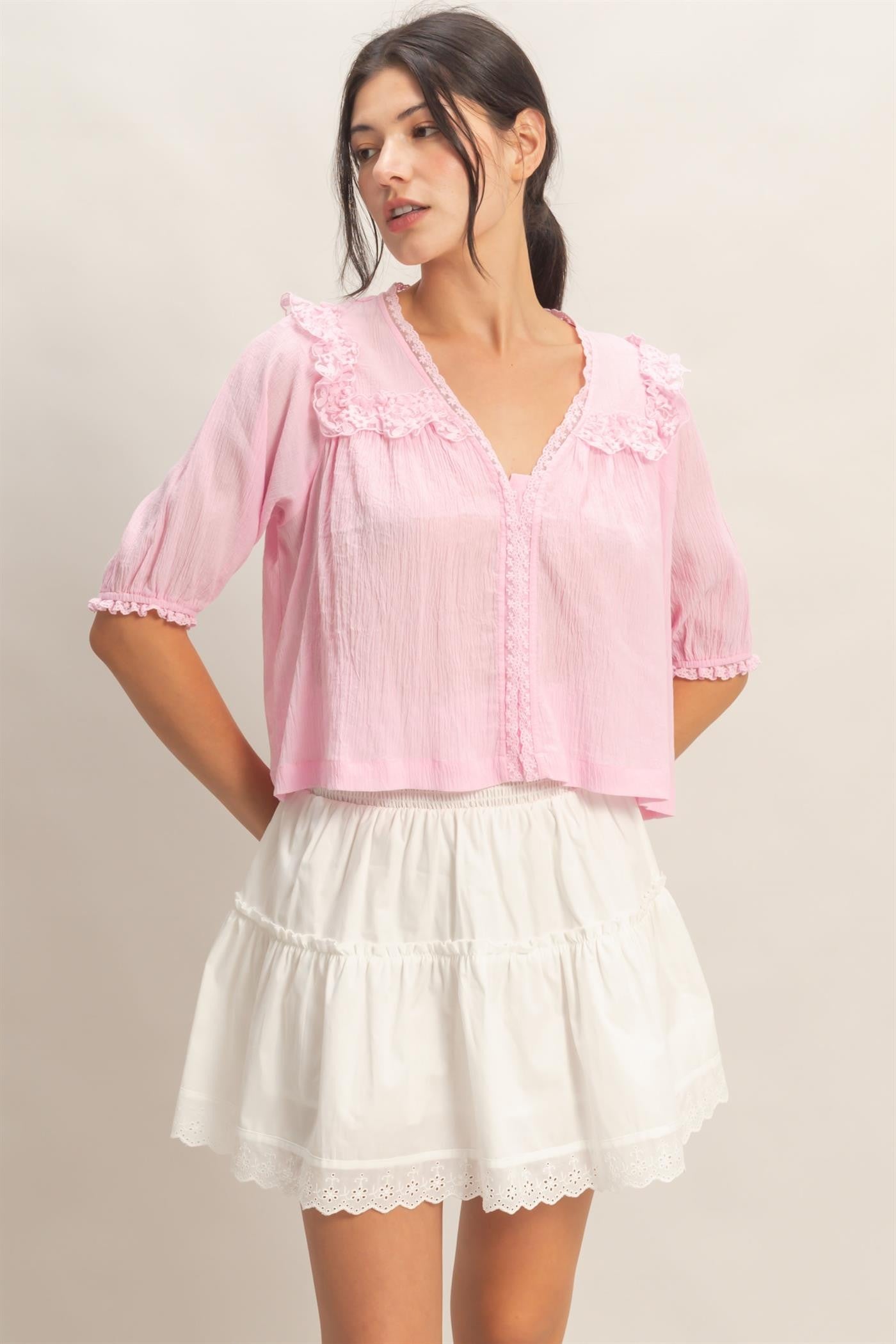  Lace Trim V-Neck Top features delicate ruffled lace accents and a relaxed silhouette 