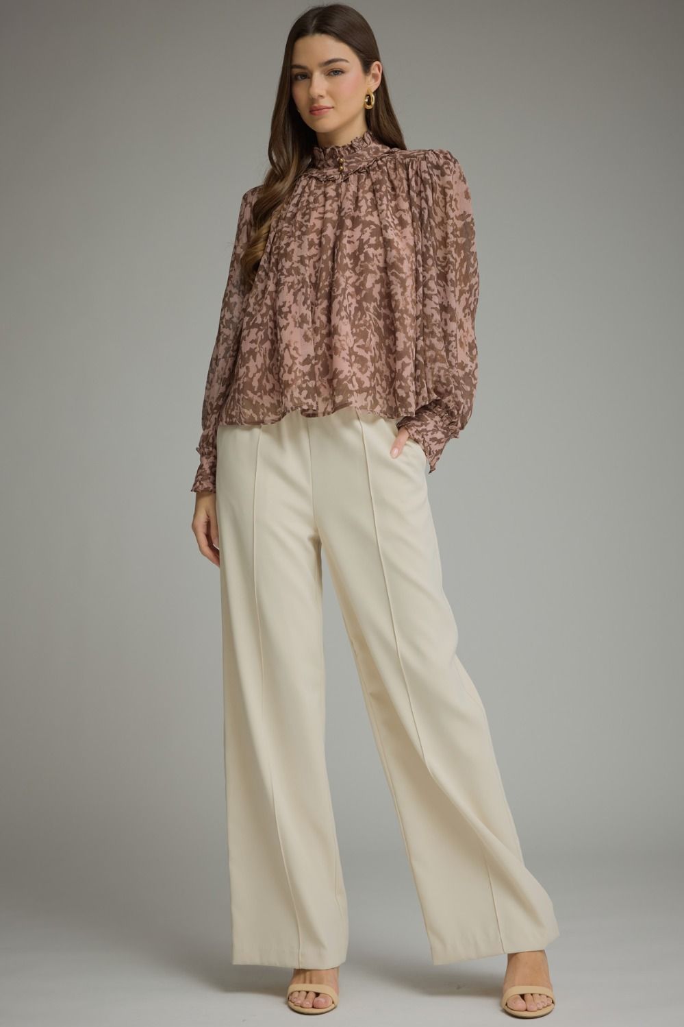 A romantic printed blouse featuring voluminous puff sleeves, a feminine ruffle neckline, and delicate gathered details for an effortlessly polished look.