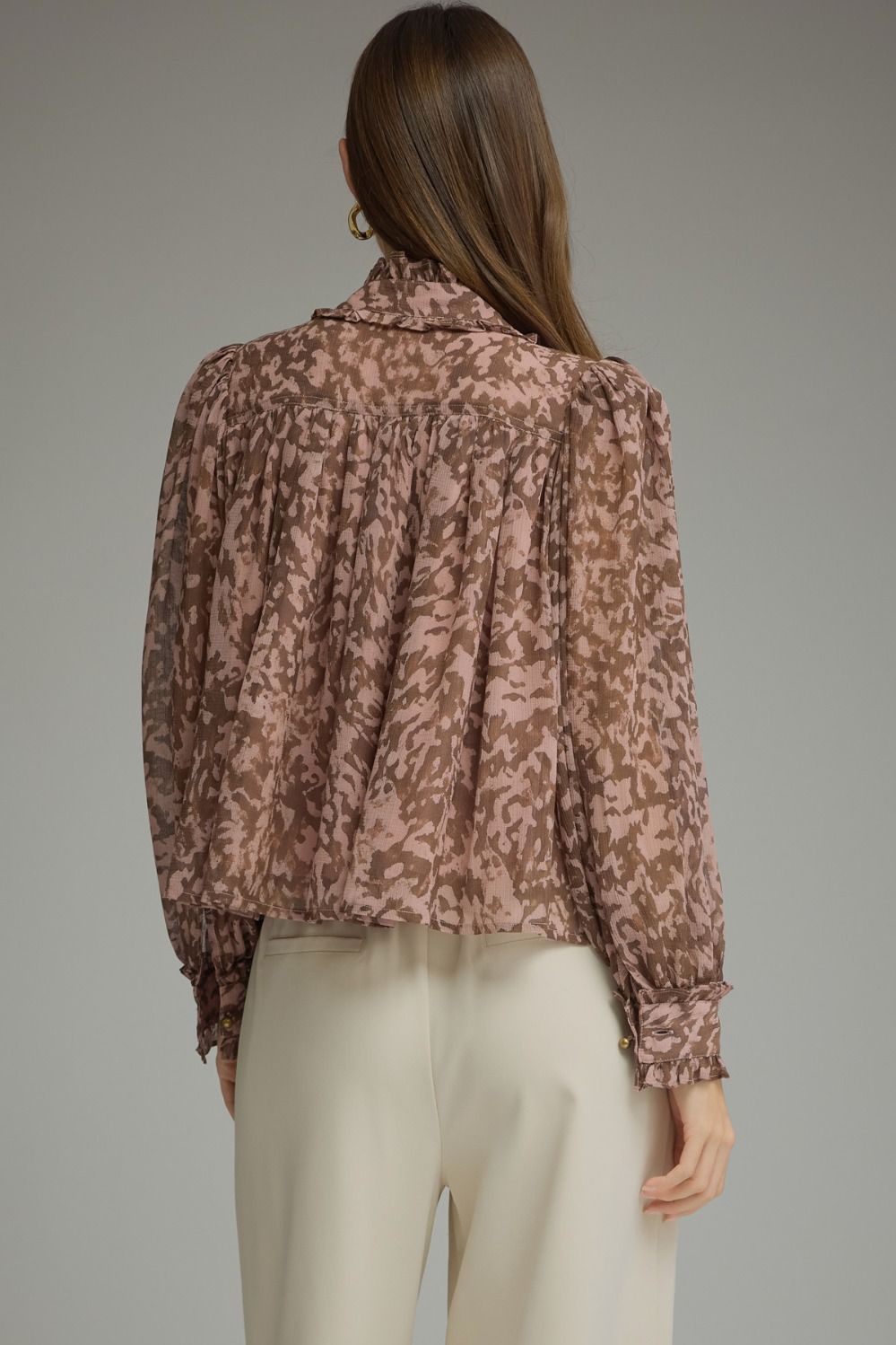 A romantic printed blouse featuring voluminous puff sleeves, a feminine ruffle neckline, and delicate gathered details for an effortlessly polished look.